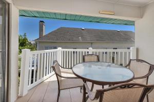 a table and chairs on the balcony of a house at Shipwatch #307 in Saint Simons Island
