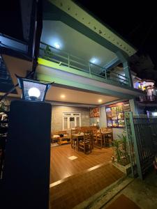 a restaurant with a dining room with a balcony at Hotel Shera Pokhara in Pokhara +15 photos