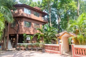 a house with a fence in front of it at Aayush Resort in Kālundri