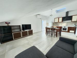 a living room and kitchen with a couch and a table at Appartamento Mare e Relax in Bellaria-Igea Marina