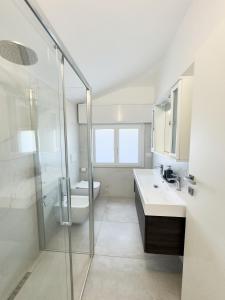 a bathroom with a shower and a sink and a toilet at Appartamento Mare e Relax in Bellaria-Igea Marina