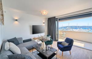 a living room with a couch and chairs and a television at Nice Home In Kastel Gomilica With Sauna in Kaštela