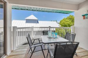 a patio with a table and chairs on a balcony at Shipwatch #311 in Saint Simons Island