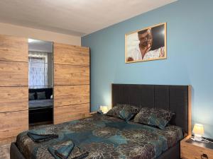 a bedroom with a large bed and a picture on the wall at Briz MK Apartment in Ravda +25 photos