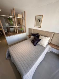 a bedroom with a bed with pillows on it at Suit Chalet Santiago in Santiago del Estero