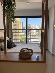 a room with a balcony with a view of a city at Suit Chalet Santiago in Santiago del Estero