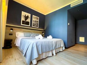 a bedroom with a large bed with a blue wall at Hotel Lis Mallorca in Palma de Mallorca +63 photos