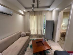a living room with a couch and a table at Chalet rozza in El Alamein