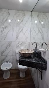 a bathroom with a sink and a toilet at Duquesa Valentina Hotel in Salta +14 photos