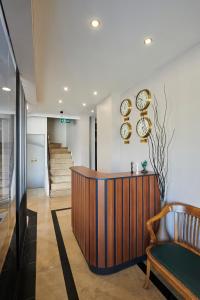 a lobby with a desk and a chair and stairs at Pera Life in Istanbul