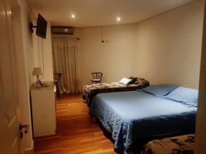 a hotel room with two beds and a television at Duquesa Valentina Hotel in Salta