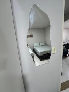 a bedroom with a bed and a mirror at Casa Lanôh in Canindé de São Francisco