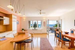 a kitchen and dining room with a table and chairs at One-Bedroom Apartment in Crikvenica IX in Sopaljska