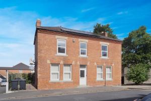 a brick building with white windows on a street at New 2BR in Pensbury Street in Darlington