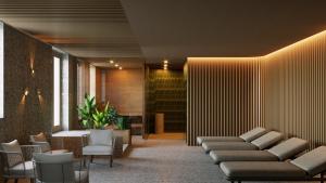 a lobby with couches and chairs in a building at Palatinus Grand Hotel in Pécs