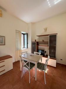 a kitchen with a table and chairs in a room at HeraDea in Crotone