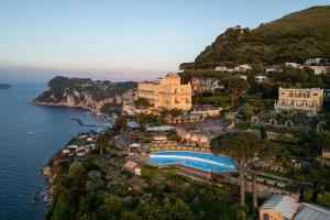 an aerial view of a resort on a hill next to the water at Hotel Caesar Augustus in Anacapri