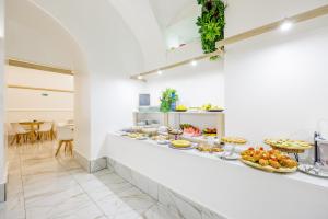 a buffet line with many plates of food on it at Palace Napoli in Naples