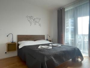 a bedroom with a bed and a large window at SAG Sky park castle wiev Free parking Free wifi in Bratislava