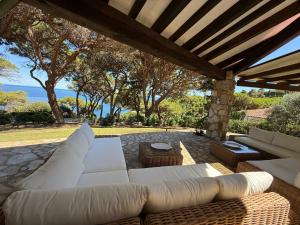 a living room with a white couch on a patio at Villa Star in Capo D'Arco