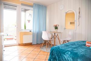 a bedroom with a bed and a table and chairs at Cała NAPRZÓD in Władysławowo