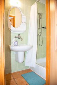 a bathroom with a sink and a mirror and a shower at Cała NAPRZÓD in Władysławowo +22 photos