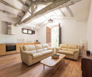 a living room with a couch and a table at Majordoms - Castell de Villavecchia - 33 pax in Sant Hilari Sacalm +86 photos