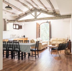 a living room with a table and chairs at Majordoms - Castell de Villavecchia - 33 pax in Sant Hilari Sacalm