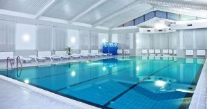a large swimming pool in a large room at Ligena Econom Hotel in Boryspil