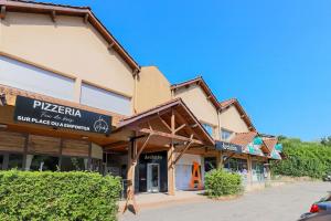a building with a sign on the front of it at Le studio de Gargantua in Dardilly