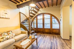 a living room with a couch and a table at Olivo Cottage - Monti 1824 in Casole dʼElsa