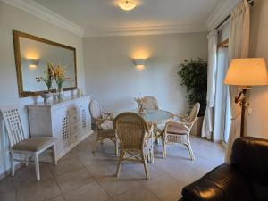 a dining room with a table and chairs at Beautiful Villa on Boavista Golf Resort - Daily Service & Spa Access in Lagos