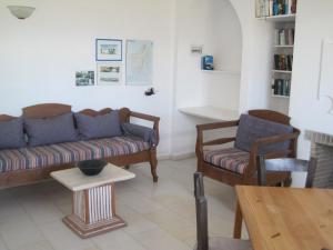 a living room with a couch and a table at Tsanakou Vineyard Glinado in Glinado Naxos