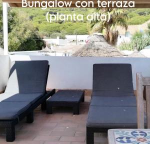 two chairs and a bench on a patio at Mandala Bungalows - Adults Only in Los Caños de Meca