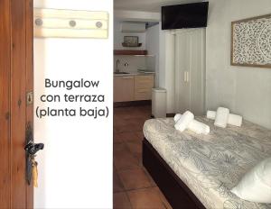 a bedroom with a bed with towels on it at Mandala Bungalows - Adults Only in Los Caños de Meca