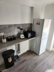 a kitchen with a counter and a refrigerator at Luxurious ensuite rooms in Basildon