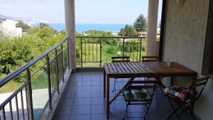 a balcony with a table and chairs and a view at Sea View in Topola