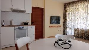 a kitchen with a white table and two chairs and a table at Sea View in Topola