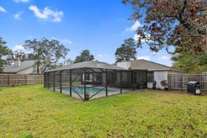 a house with a swimming pool in a greenhouse at Sunnyside Retreat, Private pool, Bluewater Bay, Sleeps 11, Fenced Yard in Niceville