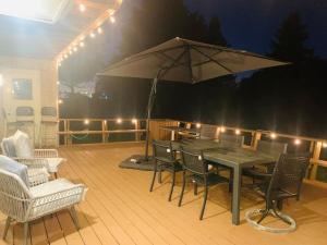 a table with an umbrella on a deck at night at Amazing Unique House in Richmond Hill in Richmond Hill