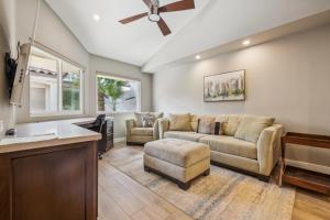 a living room with a couch and a table at Chic Palm Desert Gem - Relax, Swim, Repeat in Palm Desert