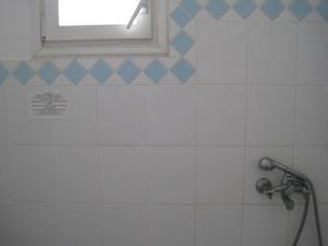 a bathroom with a shower with a window at Tsanakou Vineyard Glinado in Glinado Naxos +15 photos