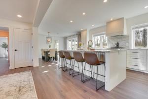 a kitchen with a bar with bar stools at Zook Manor with Hot tub Firepit and Game Room in Atglen
