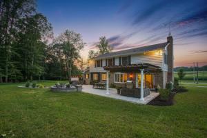 a small house with a patio and a yard at Zook Manor with Hot tub Firepit and Game Room in Atglen