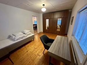 a room with a bed and a chair and a table at Central and Spacious Apartment for 4 with Sauna in Kaarina