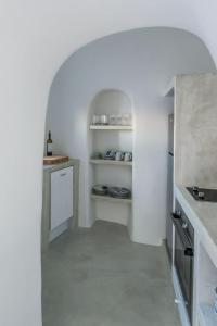 a kitchen with an arched hallway with a white kitchen at Amazing Santorini Villa 1 Bedroom Pina Caldera Villa Astounding Caldera Views & Private Plunge Pool Oia in Oia