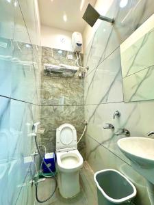 a small bathroom with a toilet and a sink at Surya Vilas Palace in Ujjain