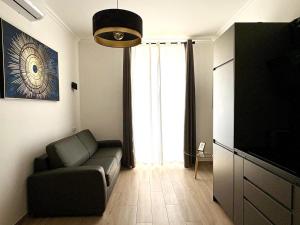a living room with a couch and a television at Central Beautifull Delille Flat in Nice