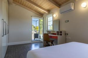 a bedroom with a bed and a desk and a window at Villa Amaranta in La Spezia +100 photos