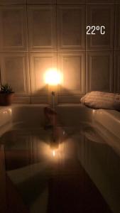 a lit light in a bath tub with a light on it at Quarto deluxe in Sao Paulo